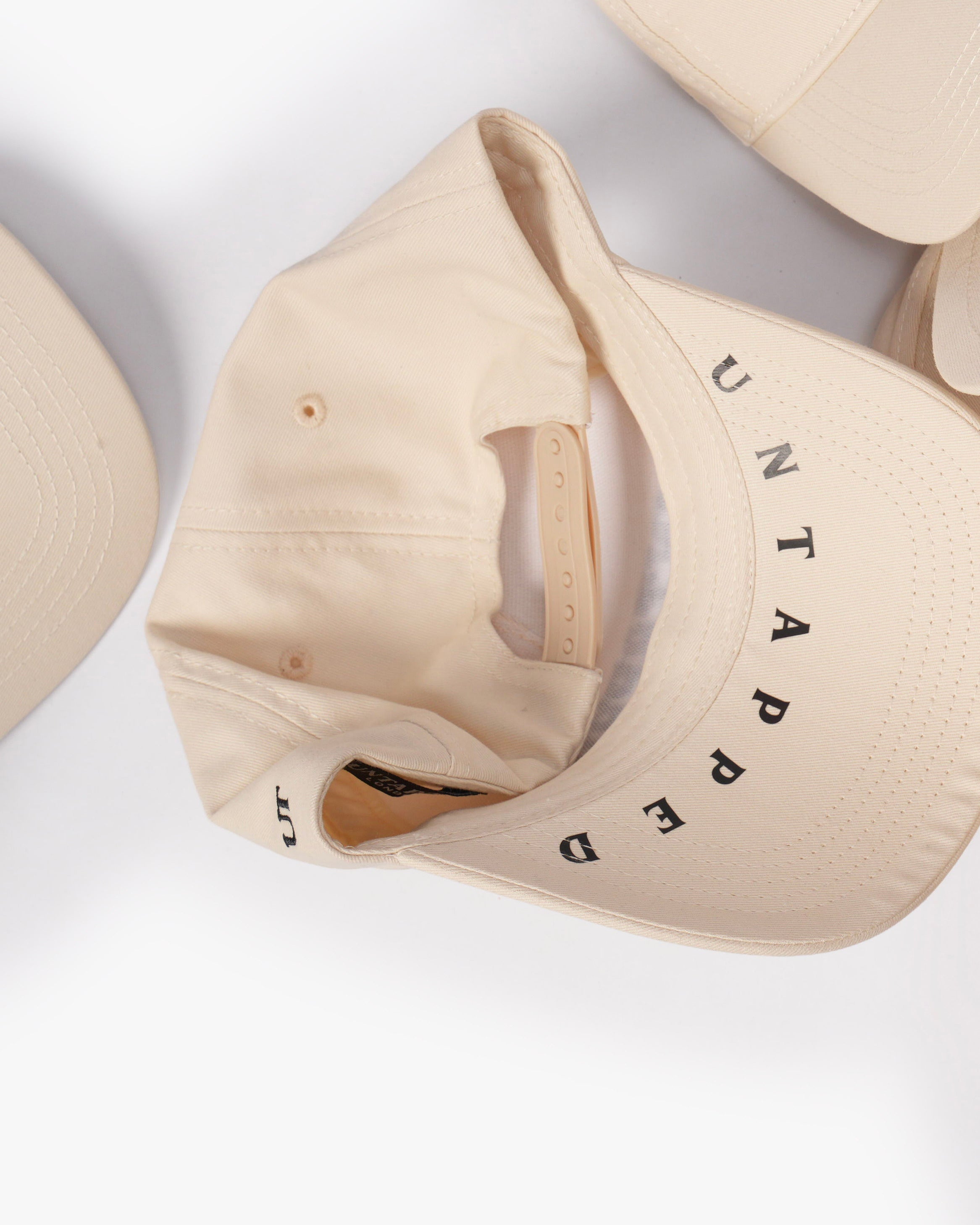 Untapped London London Script Cap in Stone Beige, structured cotton twill cap